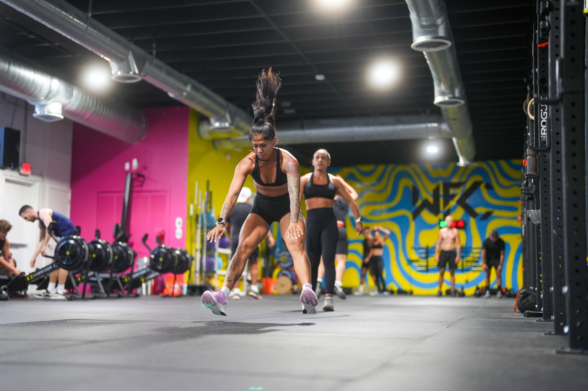 Athletes training burpee broad jumps during a HYROX class at Wynwood Fitness Club